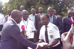 Fredrick Gume handing over instruments and documents to the incharge of DRC Revenue Authority at Mahagi-Goli border after launching the Joint Border Committee